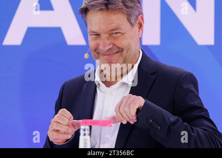 Meppen, Germany. 23rd Oct, 2023. Federal Economics Minister Robert Habeck (Greens) stands on the podium with his nameplate before the official groundbreaking ceremony for the construction of the A-North underground cable route. The new, 300-km-long route will transport two gigawatts of wind power from Emden in East Frisia to Meerbusch-Osterath in North Rhine-Westphalia. It can meet the energy needs of around two million people. Credit: Friso Gentsch/dpa/Alamy Live News Stock Photo