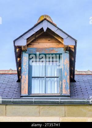 Roof gable window in need of repainting - central France. Stock Photo