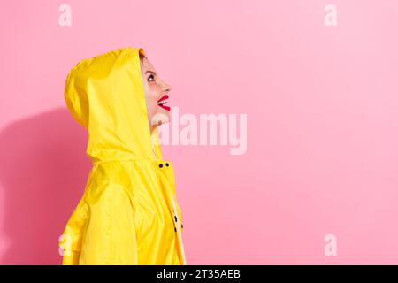 Side photo of looking up mockup interesting message testing her brand new raincoat jacket canada goose isolated on pink color background Stock Photo