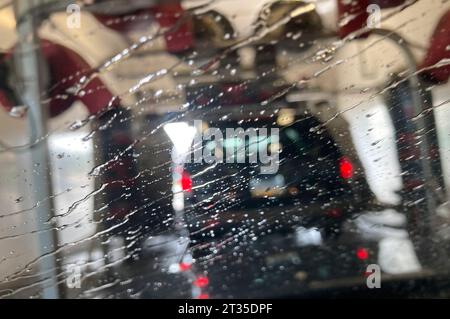 Streaks of water on windshield from inside of car wash interior USA Stock Photo