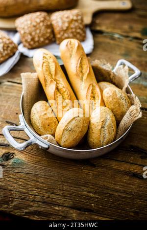 Two baguettes and four rye bread rolls in a pot Stock Photo