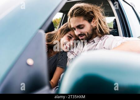 Happy young couple in a car Stock Photo