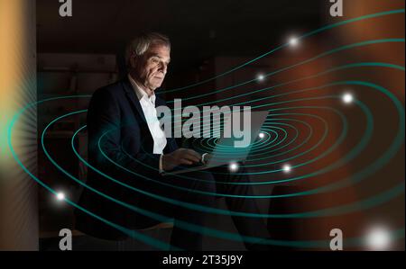 Digital composite image of senior businessman using laptop with futuristic network Stock Photo
