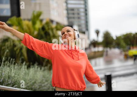 Carefree woman enjoying music and dancing Stock Photo