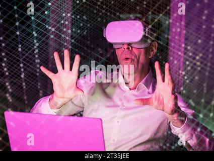 Businessman using virtual reality simulator with graphical user interface Stock Photo