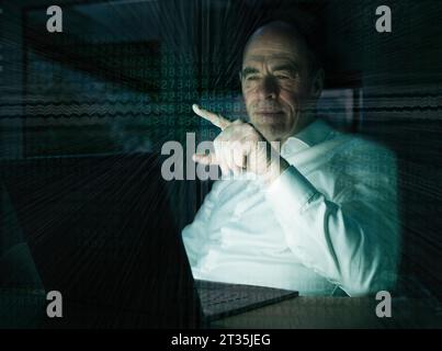 Businessman pointing on graphical user interface with binary codes in office Stock Photo