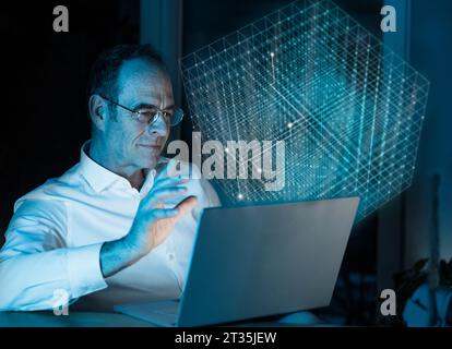 Digital composite image of businessman using laptop with 3D cube in office Stock Photo