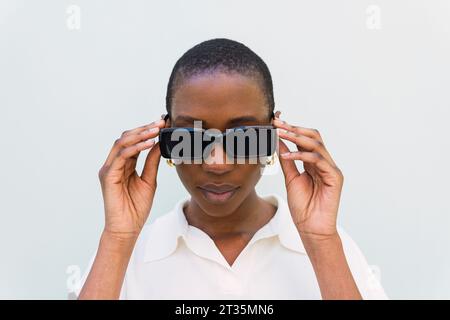 Young woman wearing sunglasses against white background Stock Photo