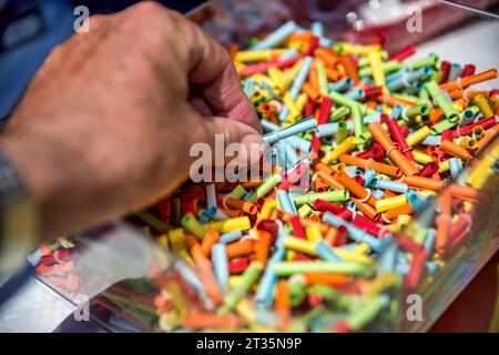 Hand of man choosing from multi colored raffle tickets Stock Photo