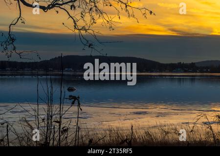 Yellow sunset over clear water Stock Photo