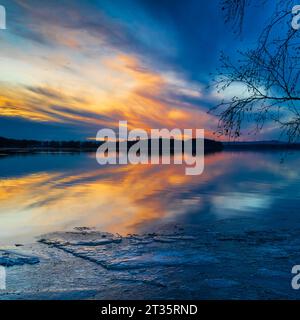 Golden sunset over frosty lake Stock Photo