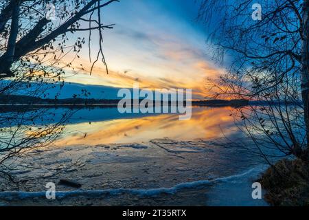Sunset over frosty lake Stock Photo