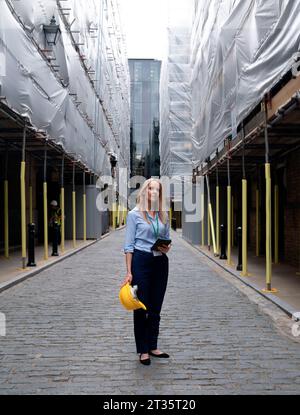 Engineer standing on footpath at construction site Stock Photo