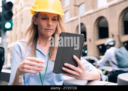 Engineer using tablet PC at street Stock Photo