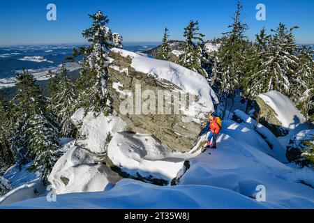 Woman hiking on snow covered mountain Stock Photo