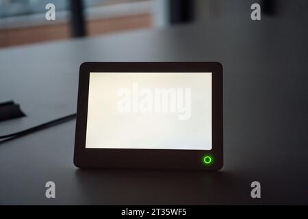Tablet PC with white blank screen at desk Stock Photo
