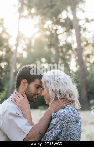Romantic couple staring at each other on sunny day Stock Photo