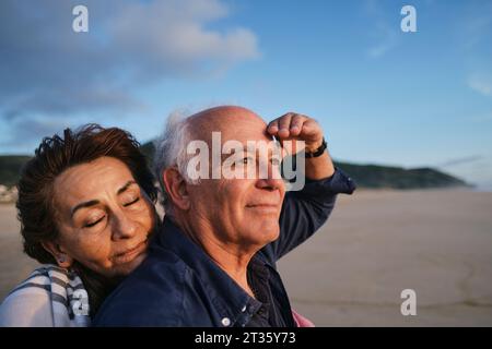 Smiling senior couple enjoying at beach Stock Photo