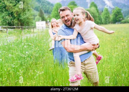 Playful father with daughter enjoying vacation Stock Photo