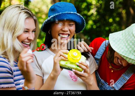 Smiling friends having fun in garden Stock Photo