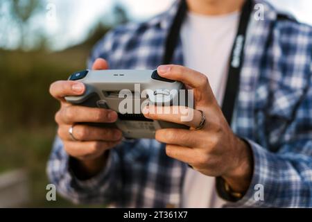 Man operating drone through remote control Stock Photo