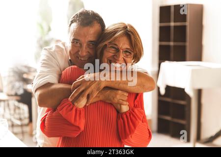 Senior couple hugging at home Stock Photo