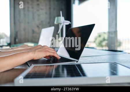 Hands of young woman typing on laptop Stock Photo