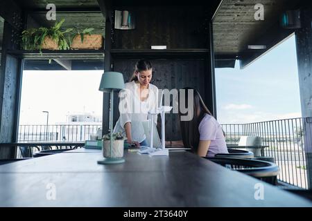Two young female engineers working together in cowrking space Stock Photo