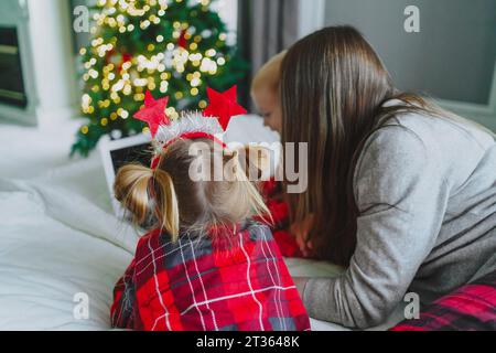 Family using laptop on bed at home Stock Photo