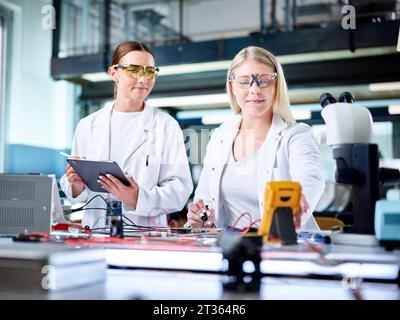 Smiling young scientists working in laboratory Stock Photo