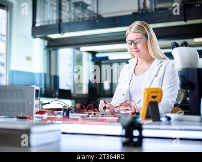 Smiling engineer working in laboratory Stock Photo
