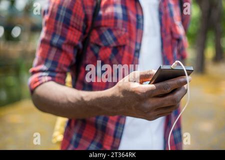 Hand of young man using smart phone Stock Photo
