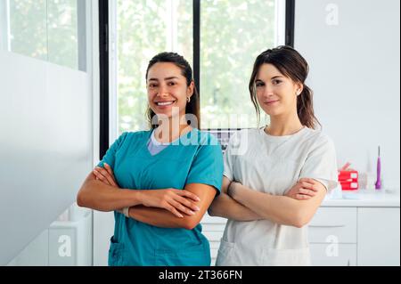 Confident multiracial dentists with arms crossed in clinic Stock Photo