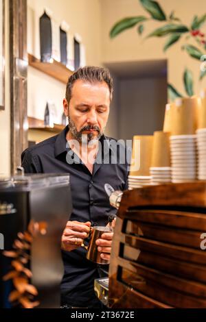 Barista making coffee in cafe Stock Photo