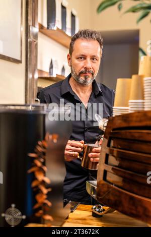 Barista preparing coffee in cafe Stock Photo