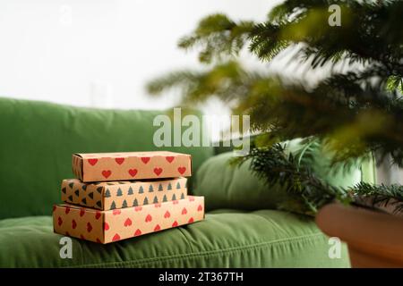 Christmas presents on green sofa at home Stock Photo