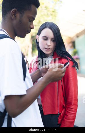 Young woman with man using smart phone Stock Photo