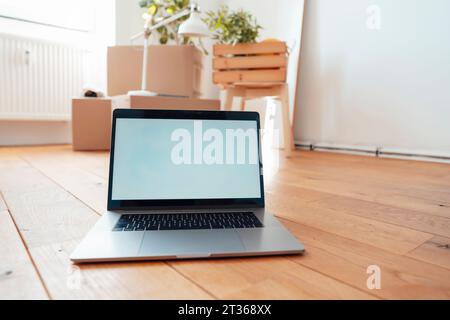 Laptop with blank screen on floor at home Stock Photo