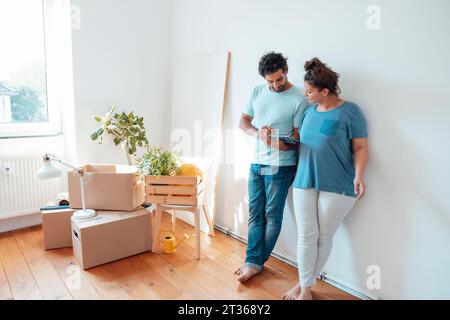 Woman with man using tablet PC at home Stock Photo