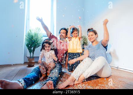 Happy family having fun with confetti at home Stock Photo