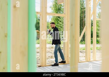 Engineer working on wood at construction site Stock Photo