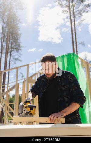 Engineer working with equipment on plank at construction site Stock Photo