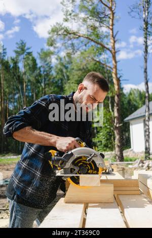 Engineer working with equipment on wood at construction site Stock Photo