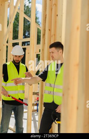 Engineers having discussion at construction site Stock Photo