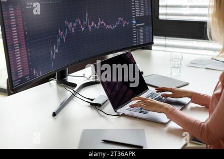 Businesswoman working on laptop at desk Stock Photo