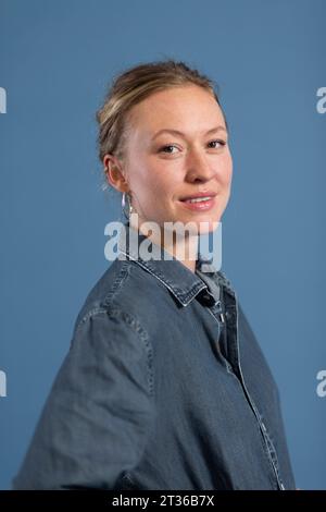 Smiling woman against blue background Stock Photo