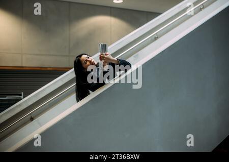 Engineer analyzing cooling module at staircase in office Stock Photo