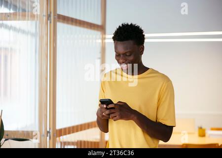 Happy student using smart phone at university Stock Photo