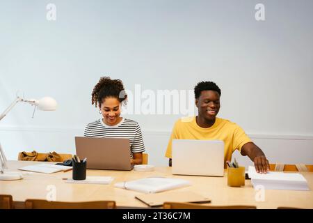 Happy students studying together at university Stock Photo