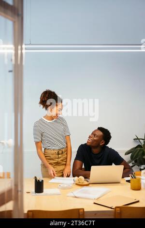 Happy young students having discussion together at university Stock Photo